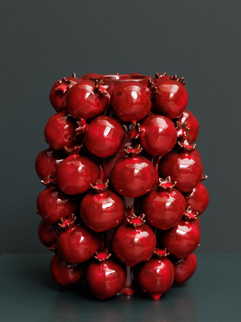 High vase of pomegranates